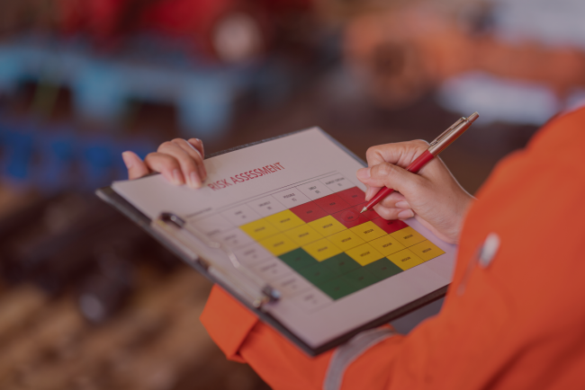 DALA Insights_Fire Risk Assessment Assessor completing a fire risk assessment risk rating matrix on a clipboard